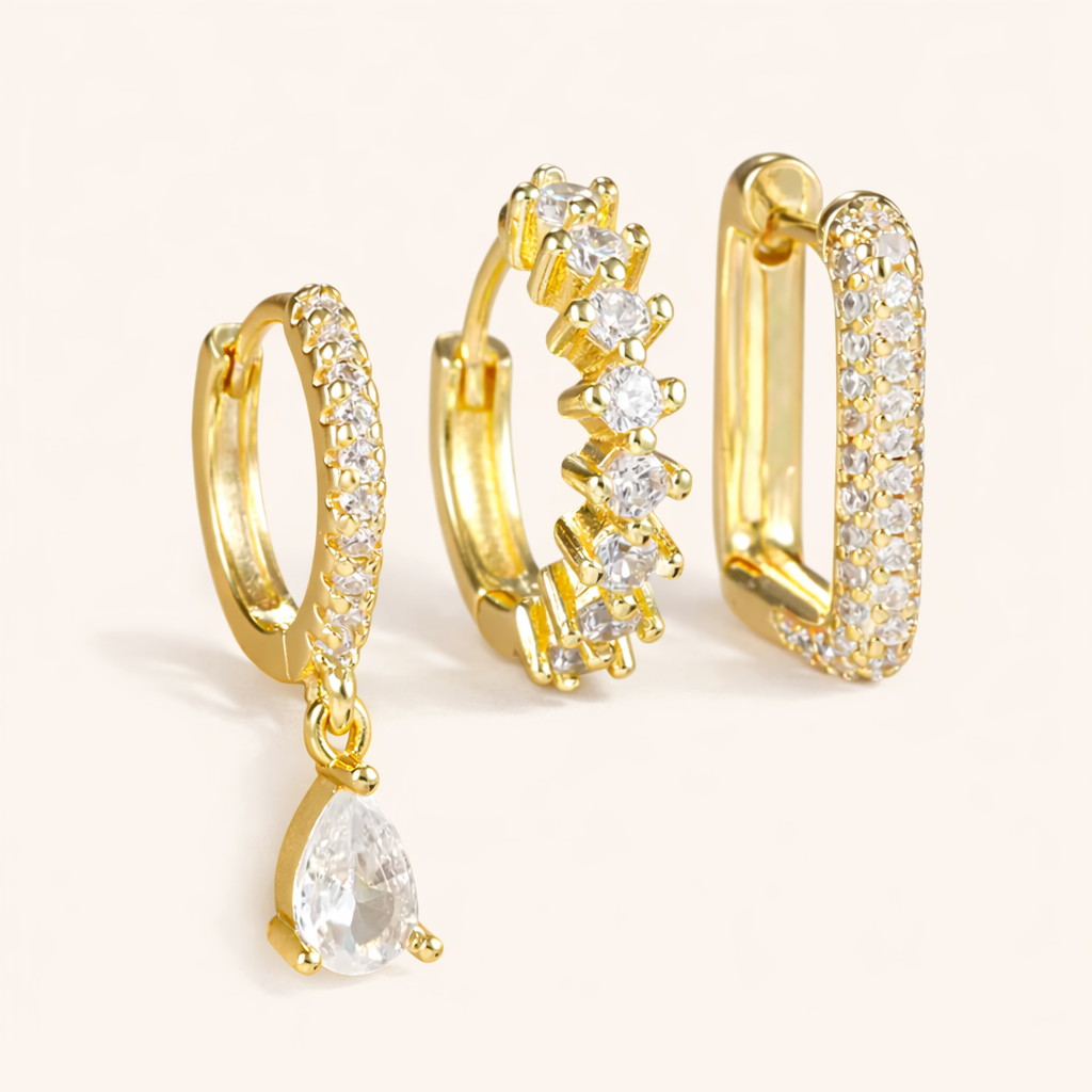 The Fia SET includes three gold pieces: a pave huggie with teardrop drop, a zigzag huggie, and a pave rectangle hoop.