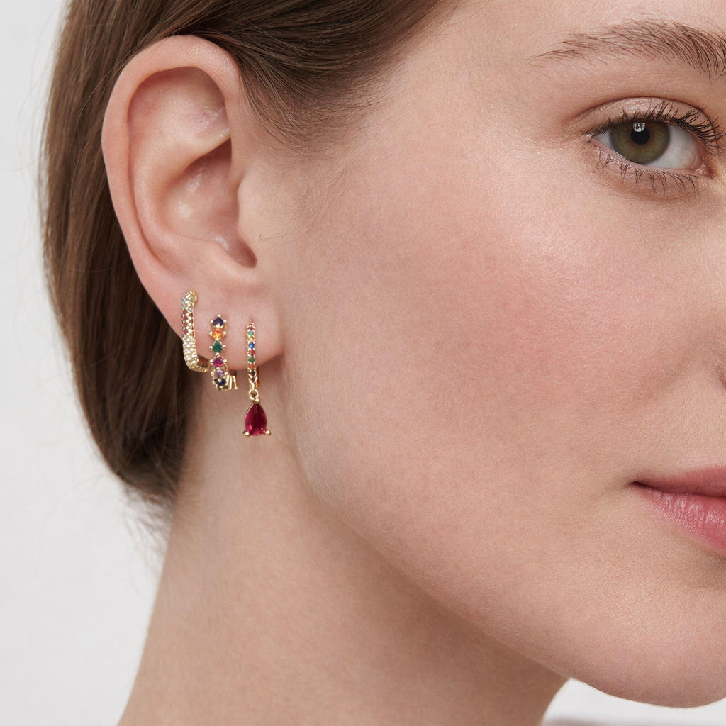 Worn along the ear, the Fia SET mixes multicolor gemstone hoops with a dangling pear-cut ruby drop charm.