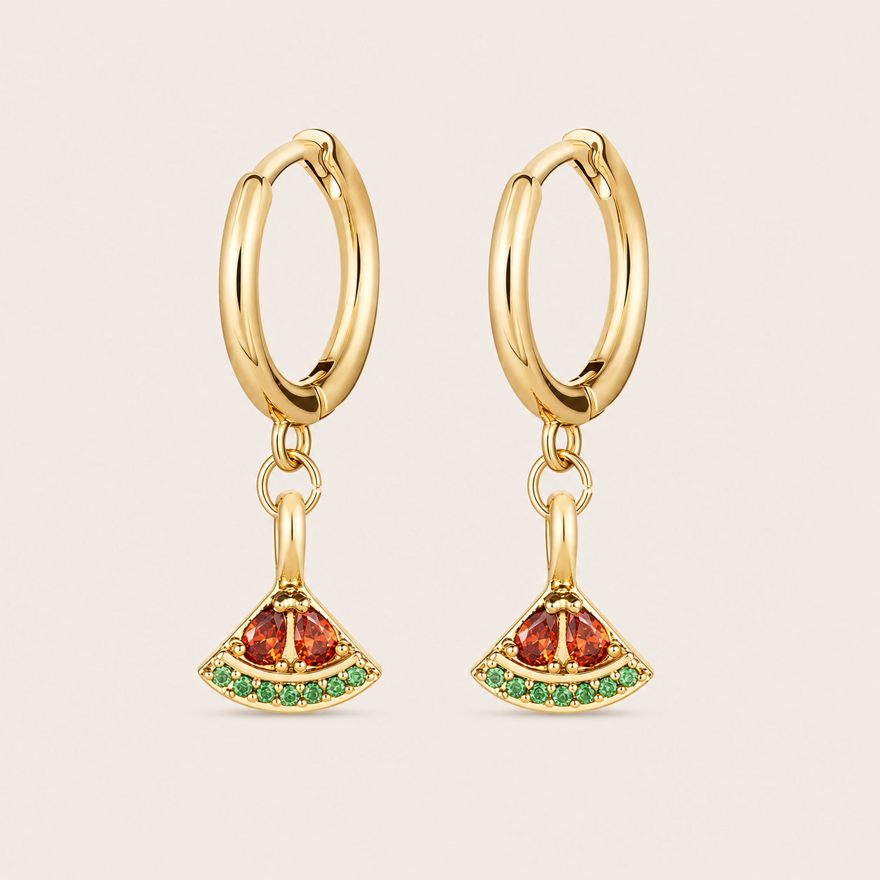 Gold hoop earrings from the Fruit Hoop EARRINGS with a fan-shaped red and green stone charm, evoking a watermelon slice.