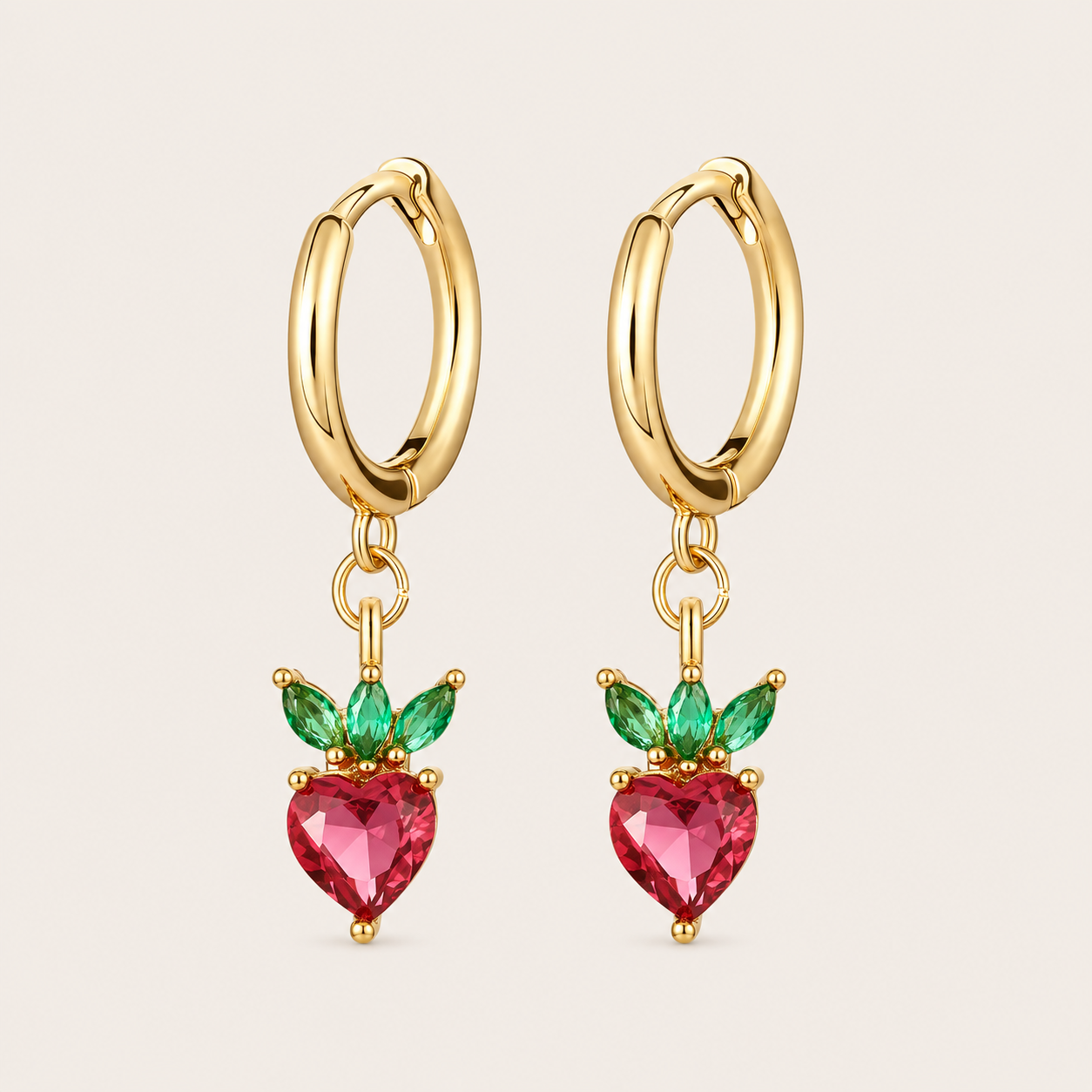 Gold hoop earrings from the Fruit Hoop EARRINGS with a strawberry-shaped charm in pink heart-cut cubic zirconia and green marquise leaves.