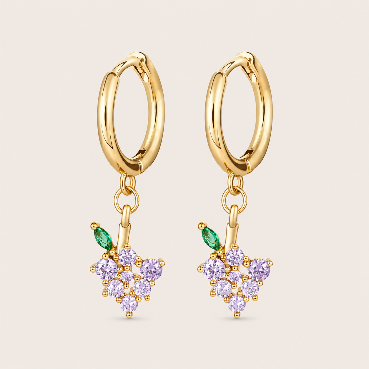 Gold hoop earrings from the Fruit Hoop EARRINGS with a grape-cluster charm in purple round cubic zirconia and a green marquise leaf.