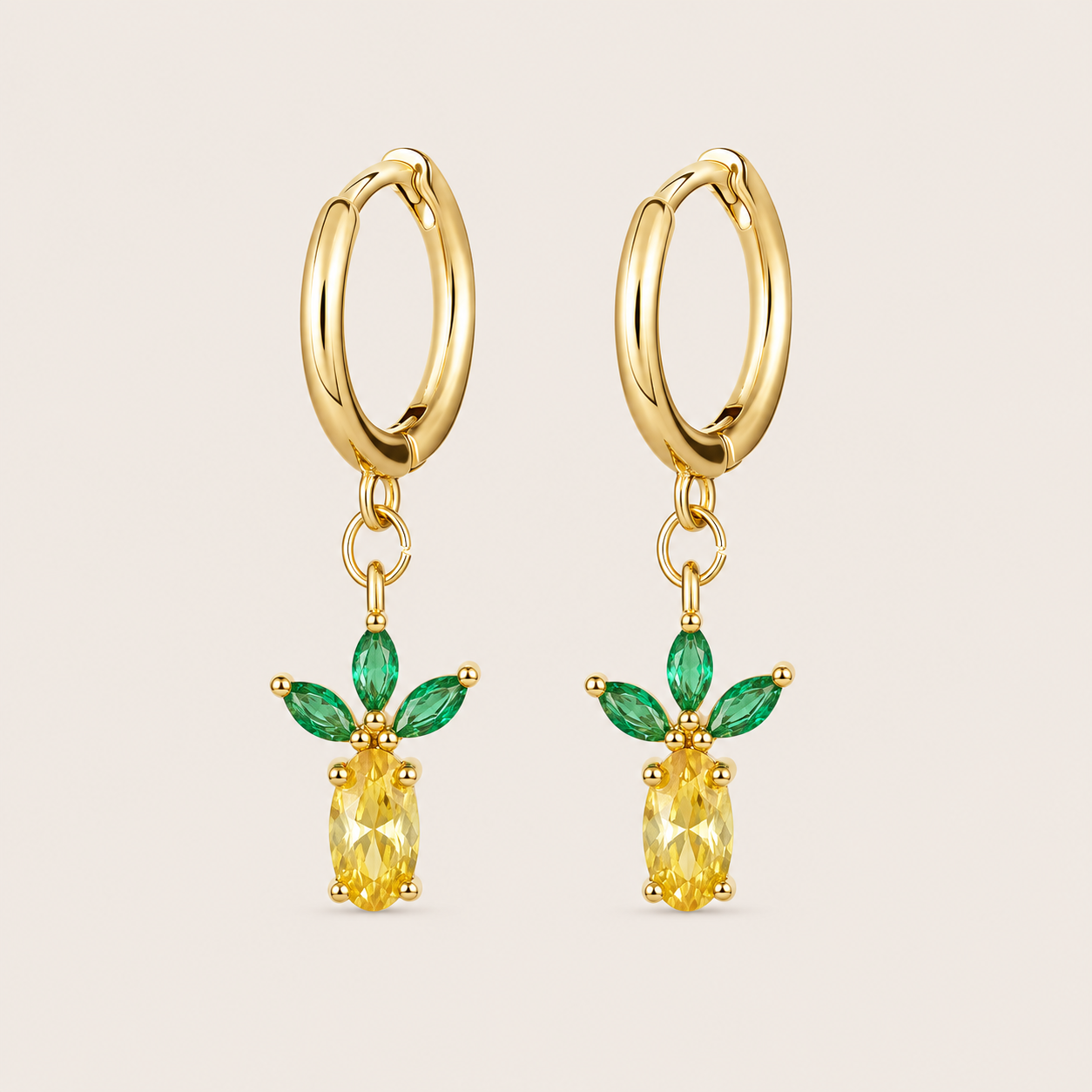 Gold hoop earrings from the Fruit Hoop EARRINGS with a pineapple-shaped charm, a yellow oval stone under fanned green marquise leaves.