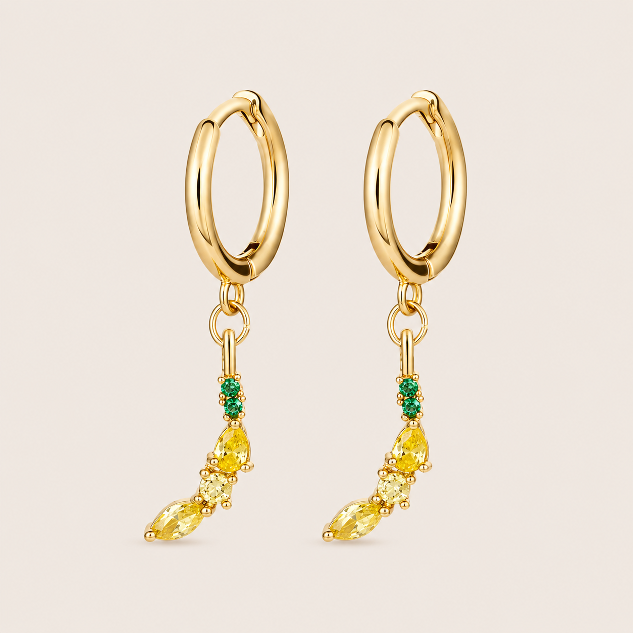 Gold hoop earrings from the Fruit Hoop EARRINGS with an elongated charm of green round and stacked yellow marquise stones, like a banana.