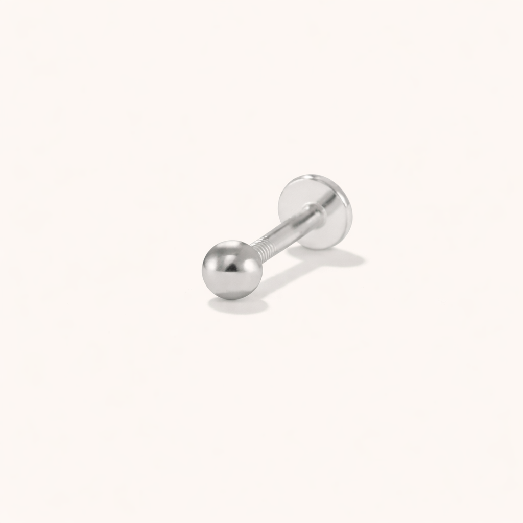 In silver tone, Glitz And Glam Piercing keeps its simple ball-end design on a threaded labret post.
