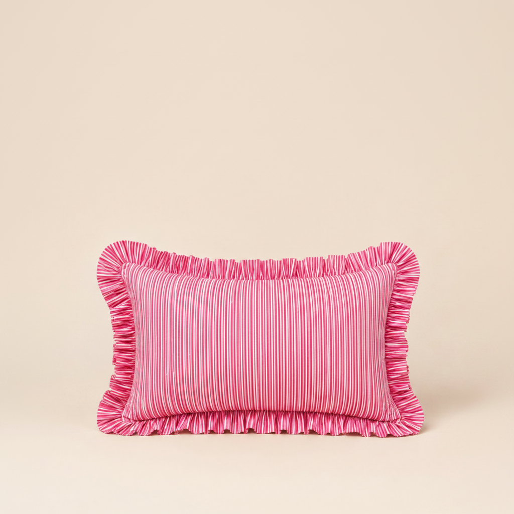 Close-up of the Harmony Pink Rectangle cushion's folded corner, showing pink linen, a red scalloped edge, and the Vive brand label.