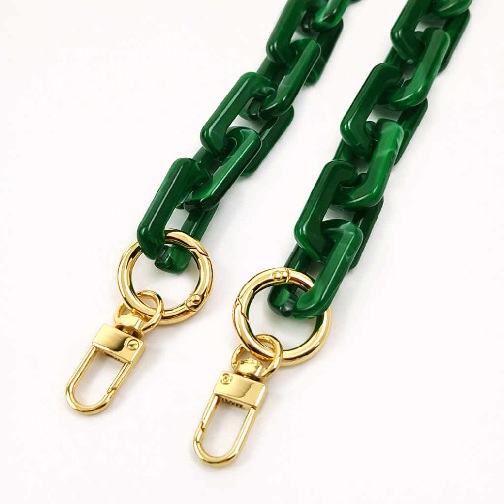 Close-up of the gold clasps on a green acrylic paperclip-link phone chain, shown on a white background.