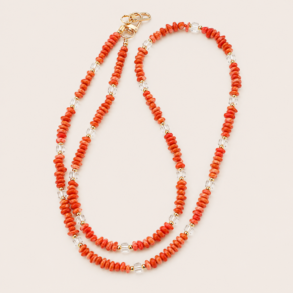 Double-strand coral and faceted clear bead phone chain with gold accents on cream — Folie à Trois Hollis long phone chain