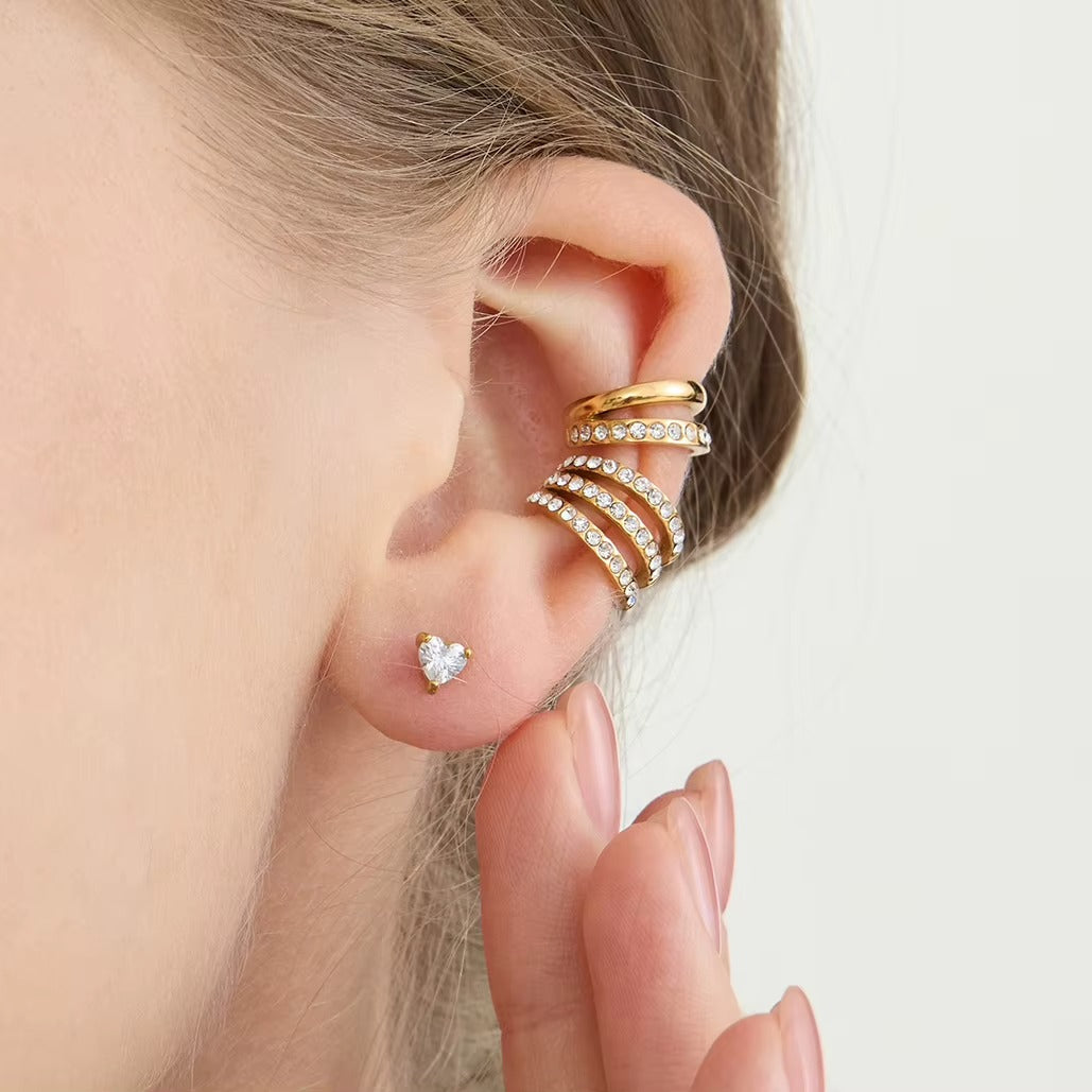 Hotline Ear Cuff worn on the ear cartilage with the hand raised, the pave crystal band above a heart-shaped stud.