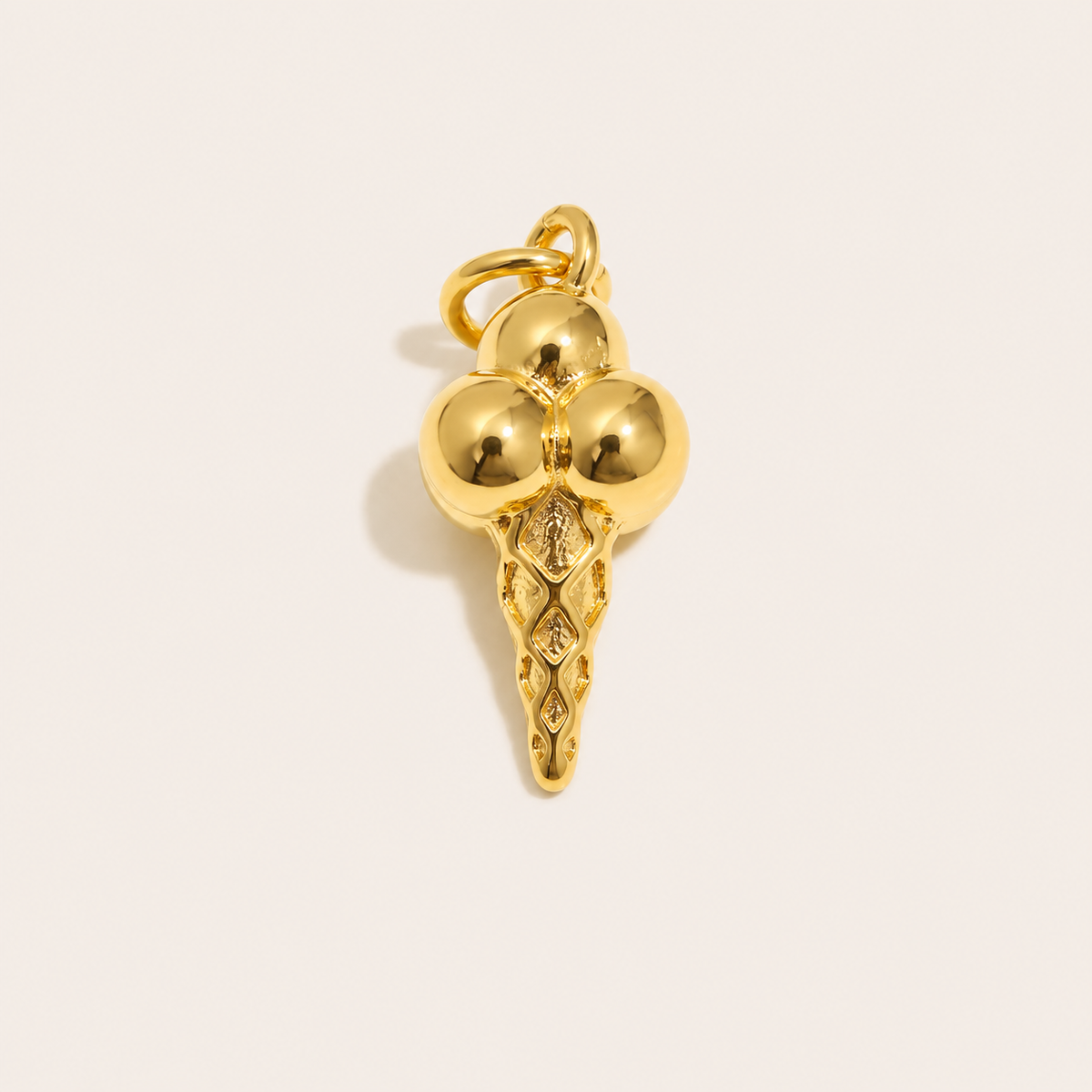 The Ice Cream CHARM in gold, shaped like a triple-scoop cone with a textured waffle base, shown alone on a plain studio background.