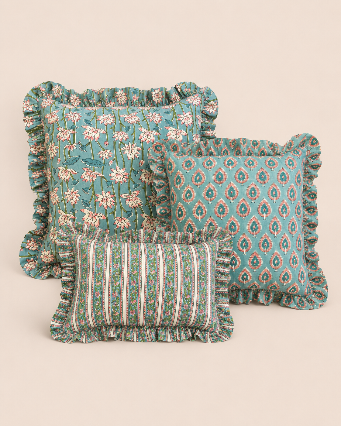 Indige Azure Peacock Cushion SET showing a teal floral square, a peacock-print square, and a green striped lumbar cushion grouped together.