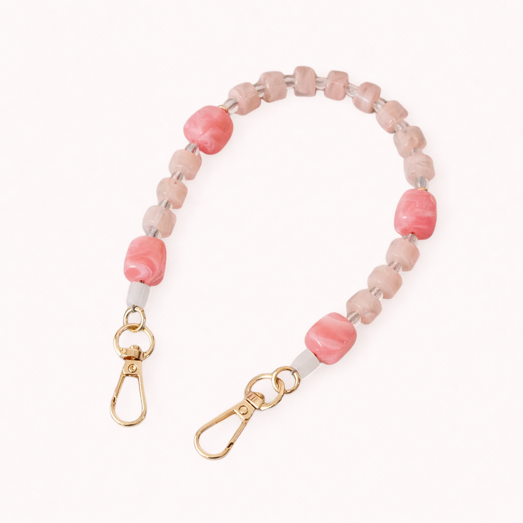 The Jaqueline SHORT PHONE STRAP in blush pink marbled beads with clear glass spacers and gold-tone lobster clasps.