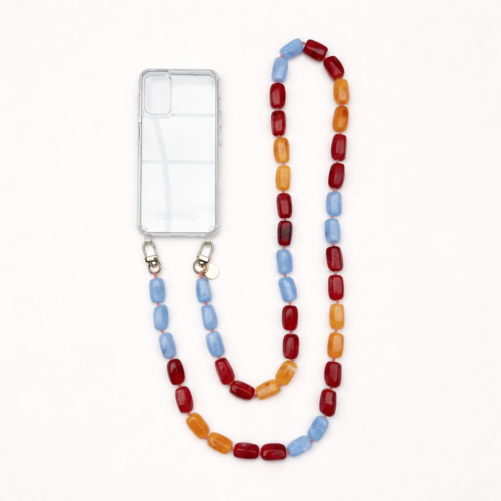 A clear phone case with a red, blue, and orange bead phone chain, shown on a cream background.