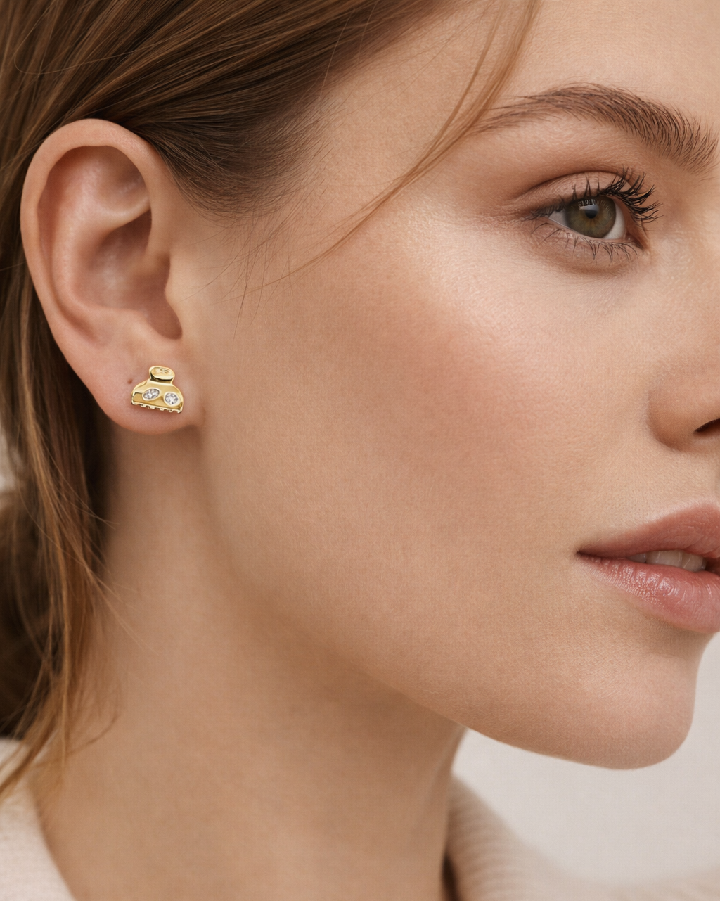Worn as a stud, Lay It On Me Earrings show their playful gold handbag shape catching light at the earlobe.