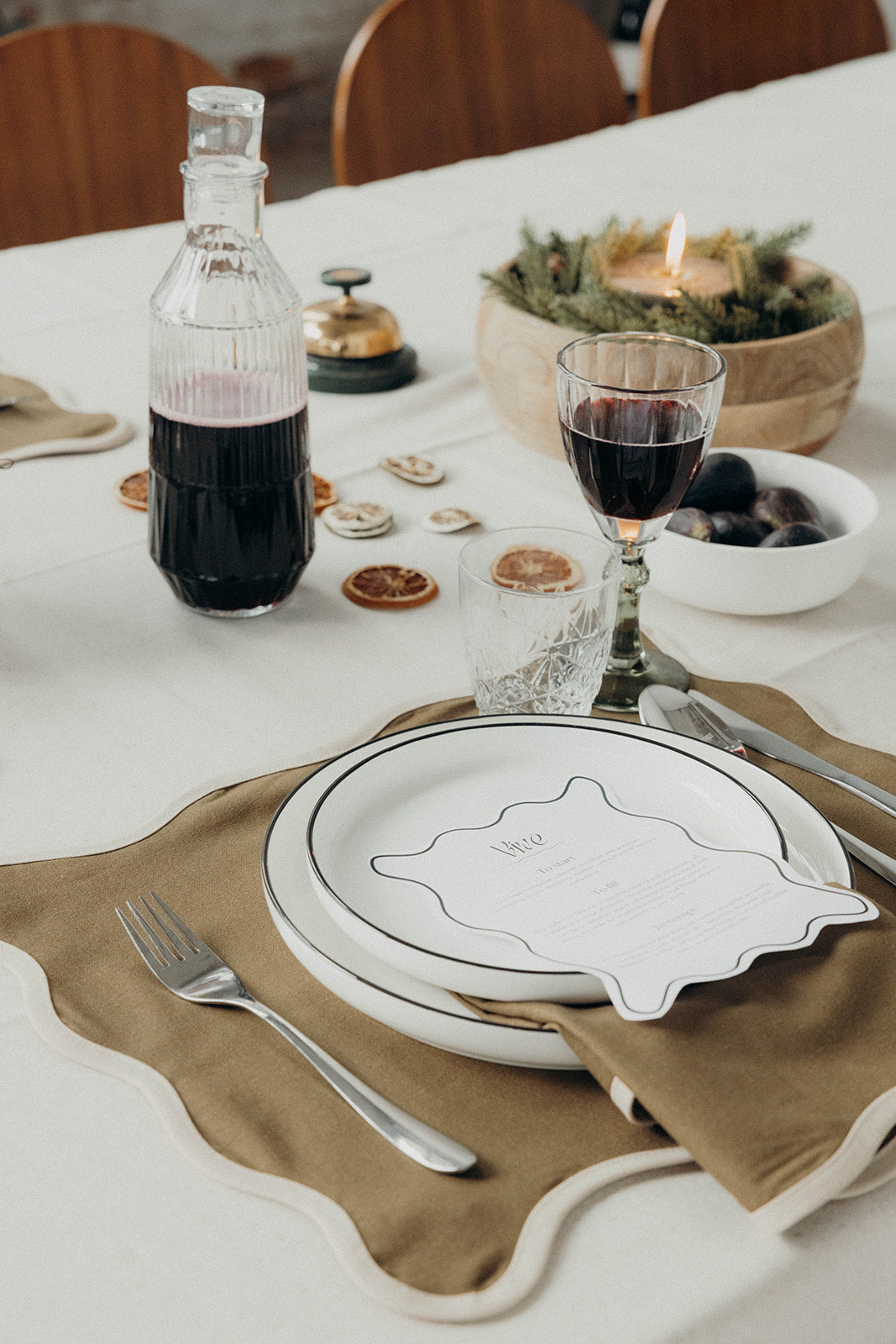 Pink Lilou Scallop placemat with wavy red scalloped trim laid flat and centered against a soft grey backdrop.