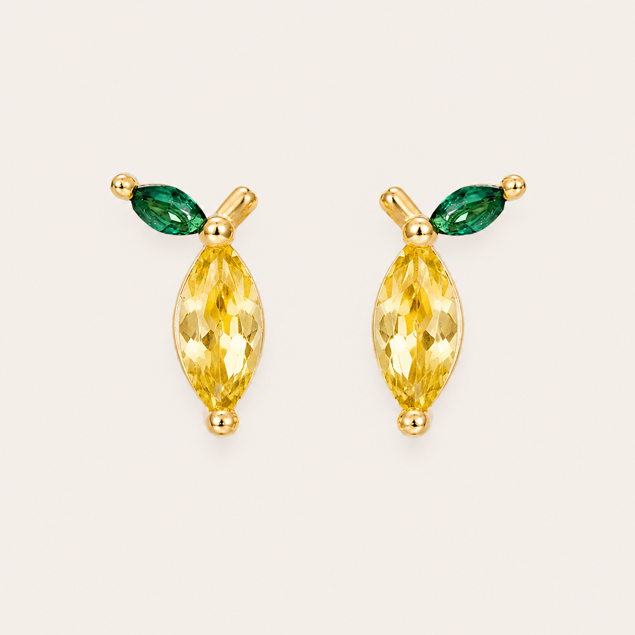 Gold stud earrings from the Little Fruit EARRINGS with a single yellow marquise cubic zirconia and a green marquise leaf accent.