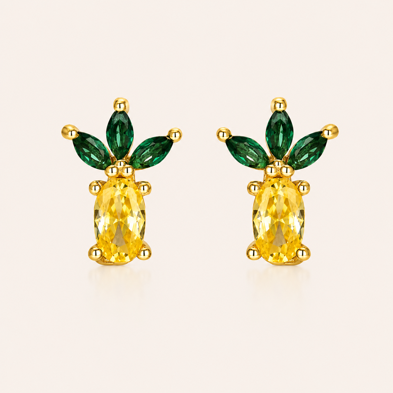 Gold pineapple-shaped stud earrings from the Little Fruit EARRINGS with a yellow oval cubic zirconia body and fanned green marquise leaves.