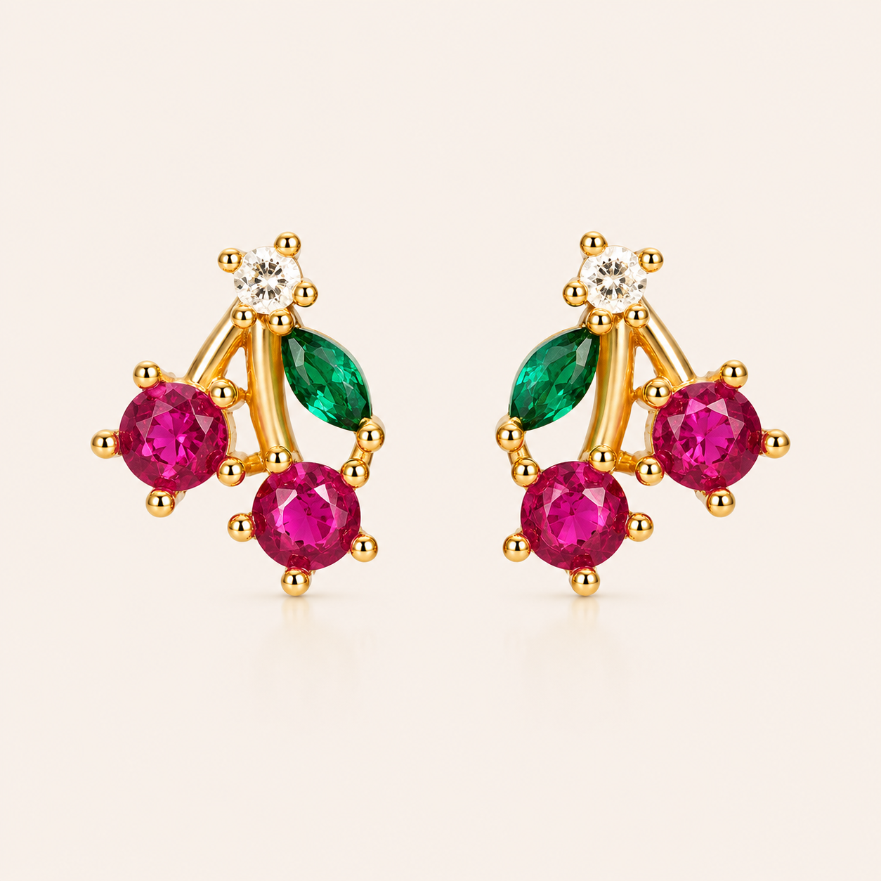 Gold cherry-pair stud earrings from the Little Fruit EARRINGS with round pink stones, a green marquise leaf, and a round white accent stone.