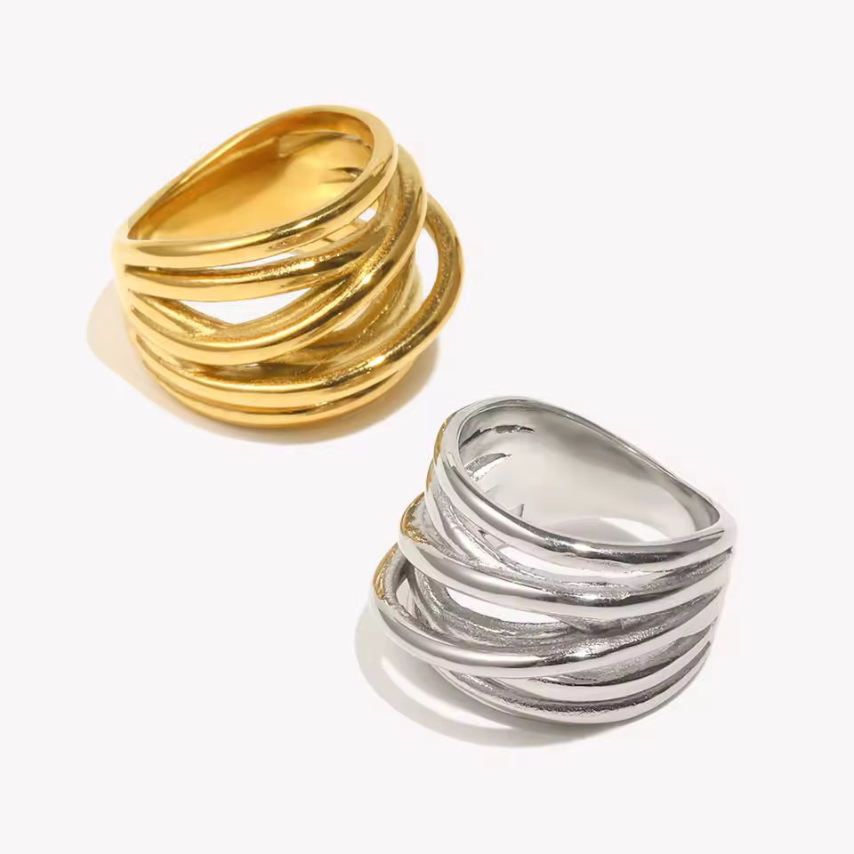 Two wide Lizie RING styles, gold and silver, each with multiple wrapped wire-like bands, shown together on a cream backdrop.