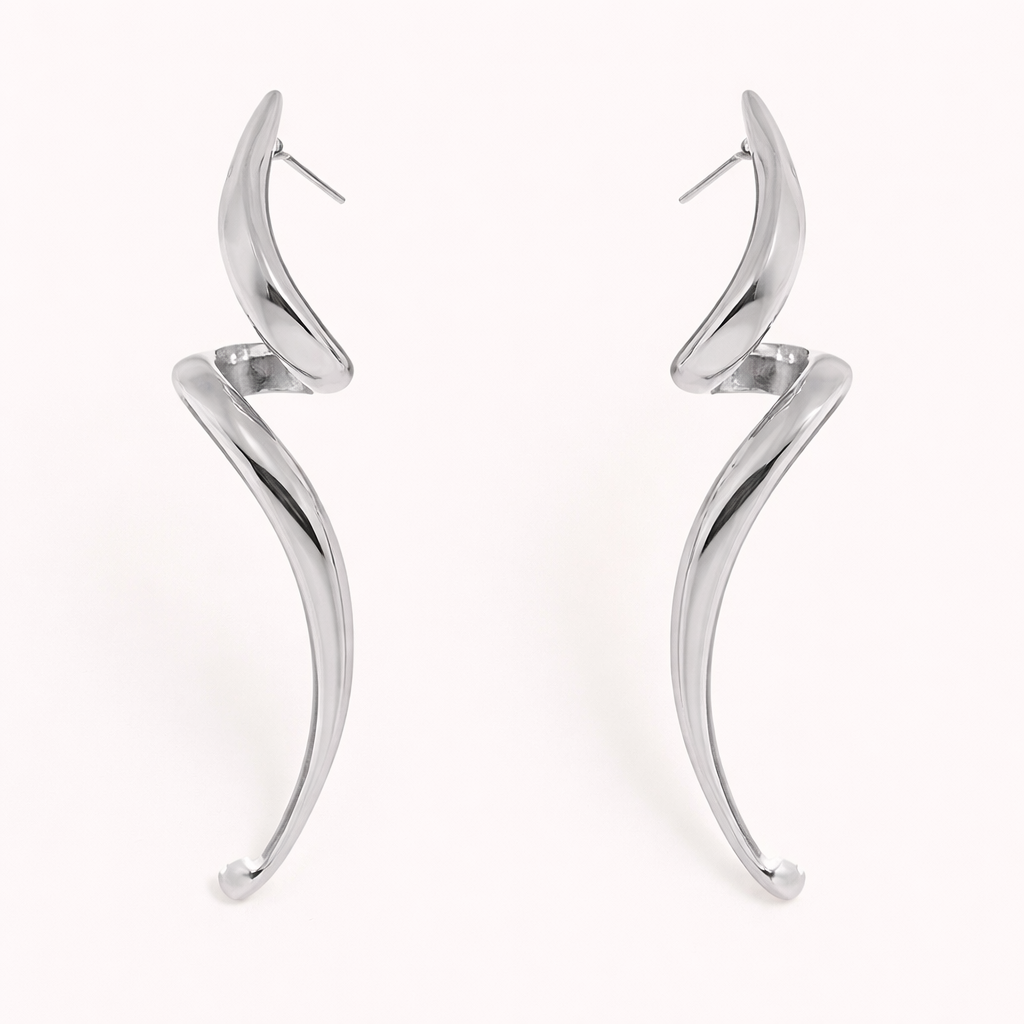 Lo Earrings in polished silver, showing the same elongated swirl design curving into a tapered point.