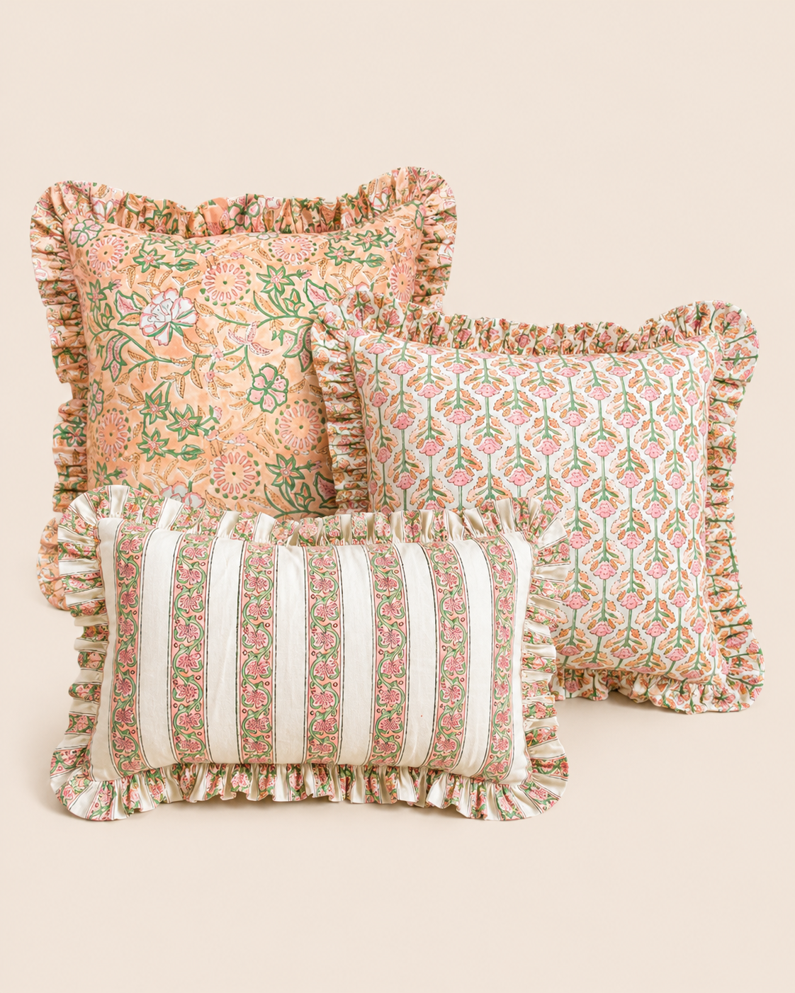 Pale pink cushion with a red scalloped edge styled on a linen tablescape with cutlery, part of the Lotus Pink cushion collection.