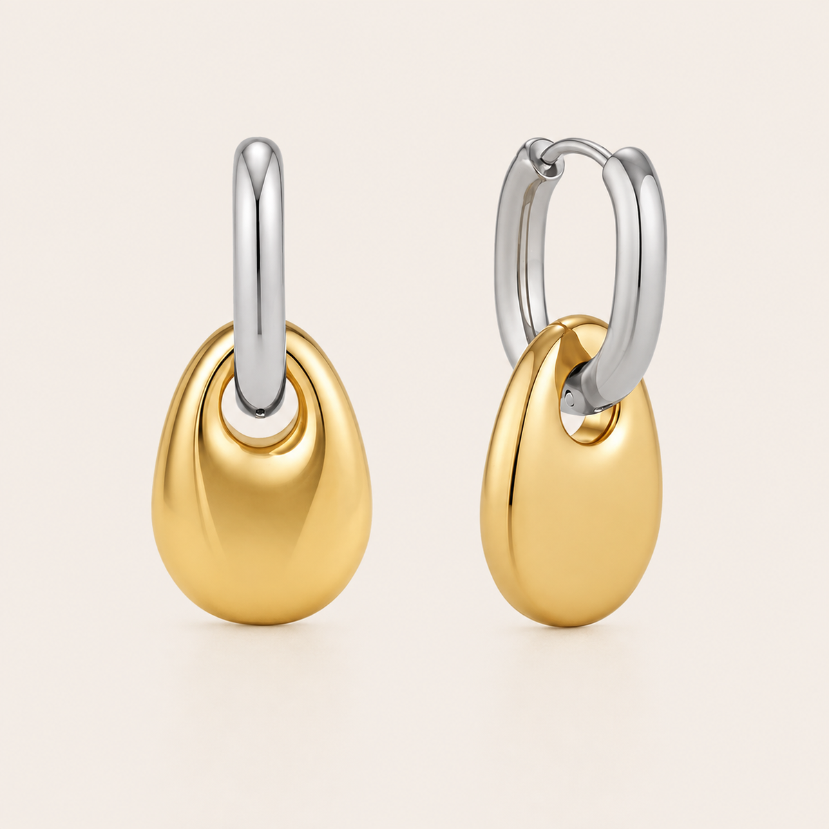 Two-tone gold and silver pebble-drop hoop earring with a glossy rounded teardrop dangling from the hoop — Folie à Trois Lucent EARRINGS.