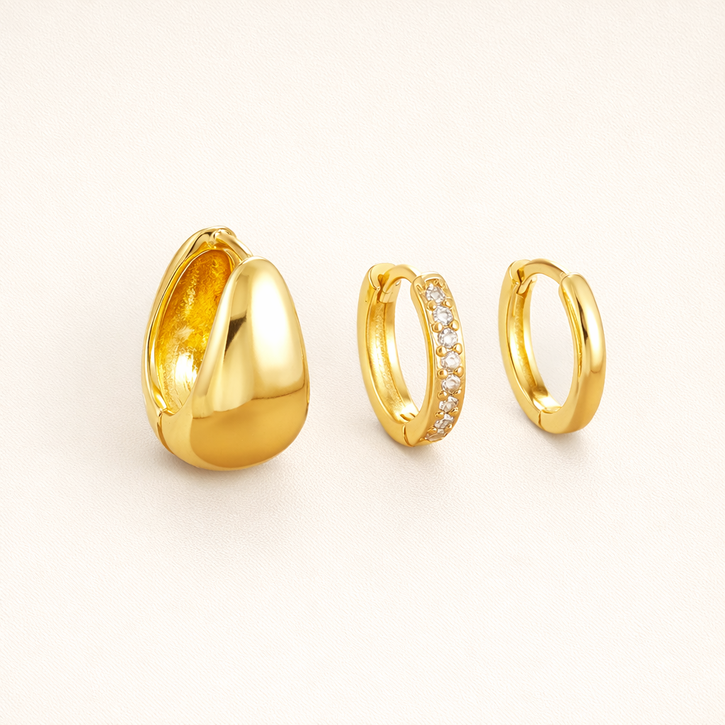 Lulu Set in gold, a chunky teardrop hoop, a pave hoop, and a plain hoop, shown together from an angle.