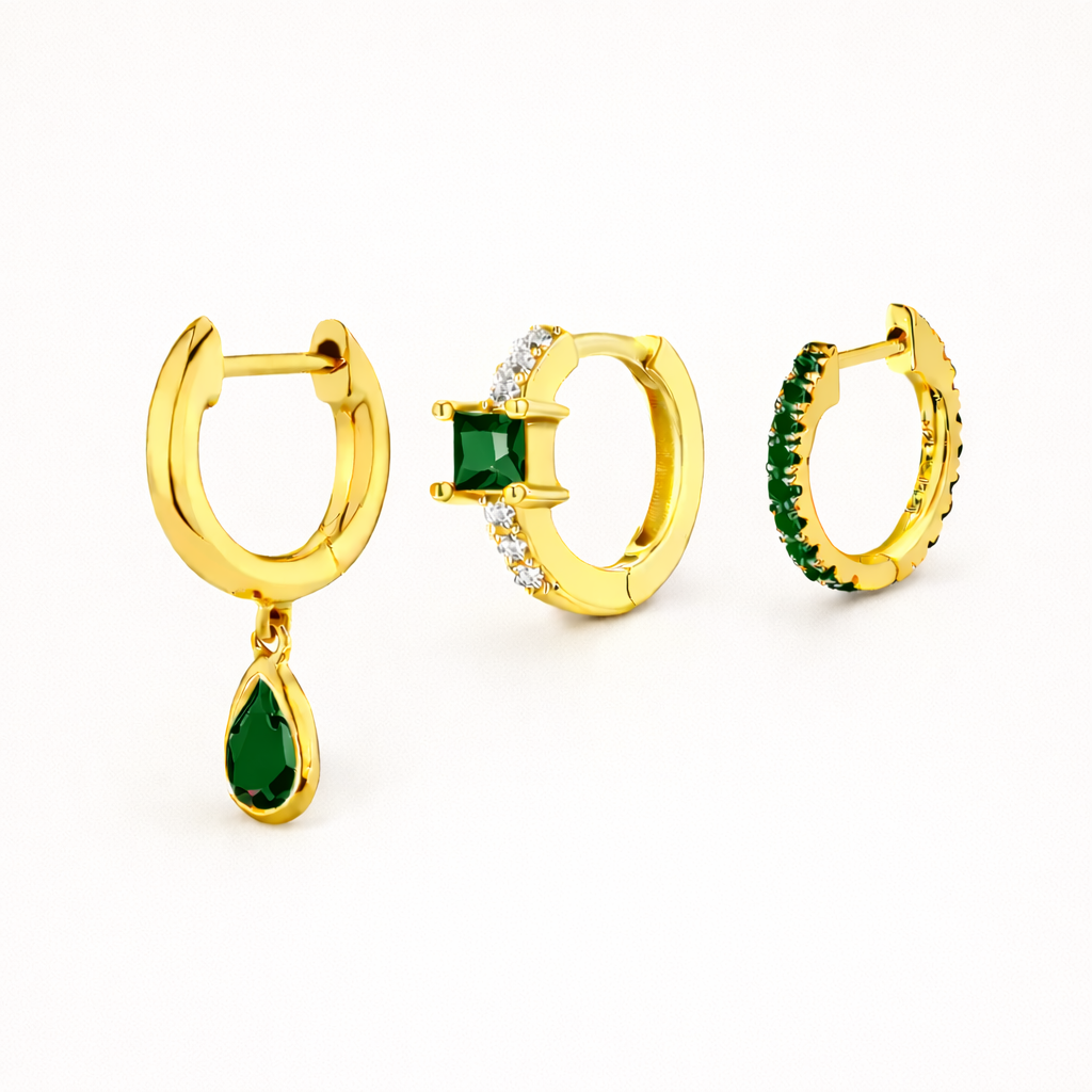 Maisie SET gathers three gold hoops: a teardrop dangle, a square-stone huggie, and a pave hoop, all in emerald green.