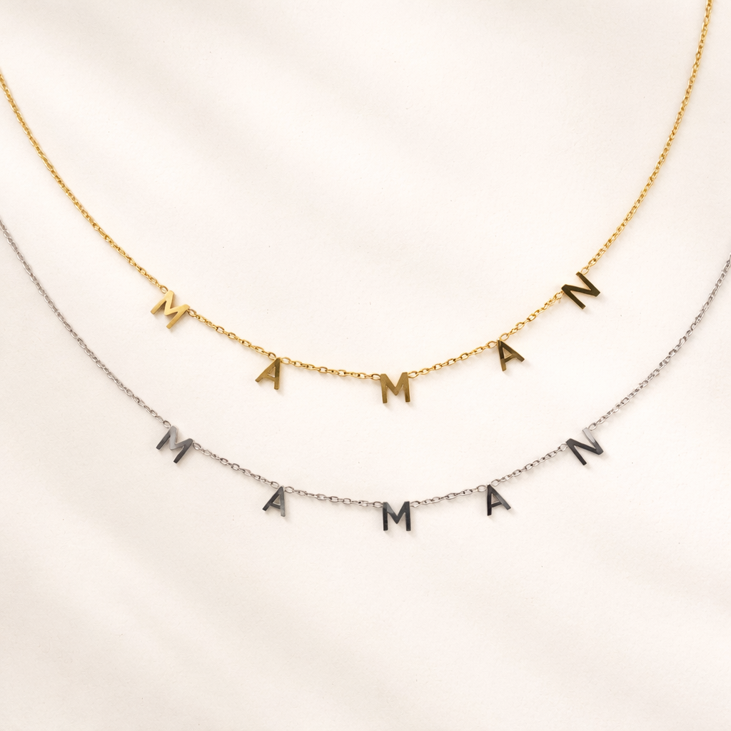 The Maman NECKLACE in gold and silver, individual letters spelling MAMAN dangling from two layered fine chains.