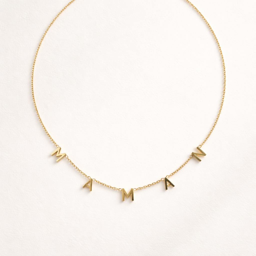 The Maman NECKLACE in gold, individual letters spelling MAMAN dangling from a fine chain, shown flat.