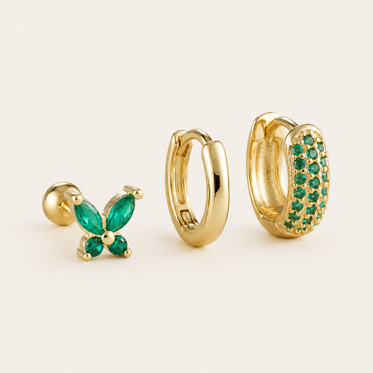 Three-piece Marigold SET gold earrings in green cubic zirconia: a butterfly stud, a plain hoop, and a pave hoop.