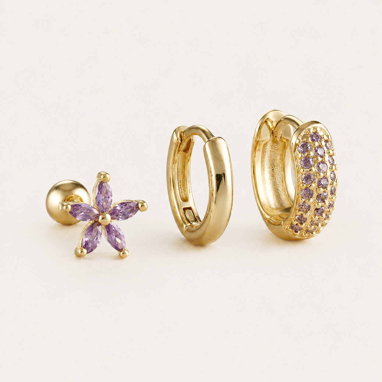 Three-piece Marigold SET gold earrings in purple cubic zirconia: a flower stud, a plain hoop, and a pave hoop.