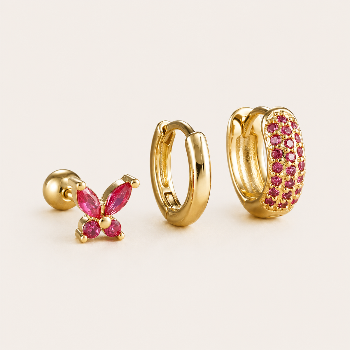 Three-piece Marigold SET gold earrings in pink cubic zirconia: a butterfly stud, a plain hoop, and a pave hoop.