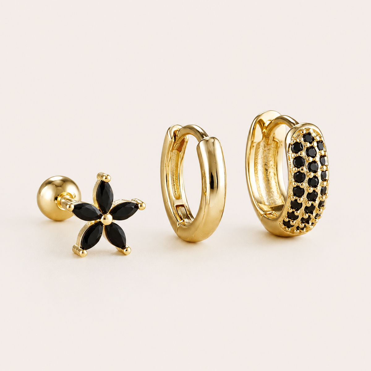 Three-piece Marigold SET gold earrings in black cubic zirconia: a flower stud, a plain hoop, and a pave hoop.
