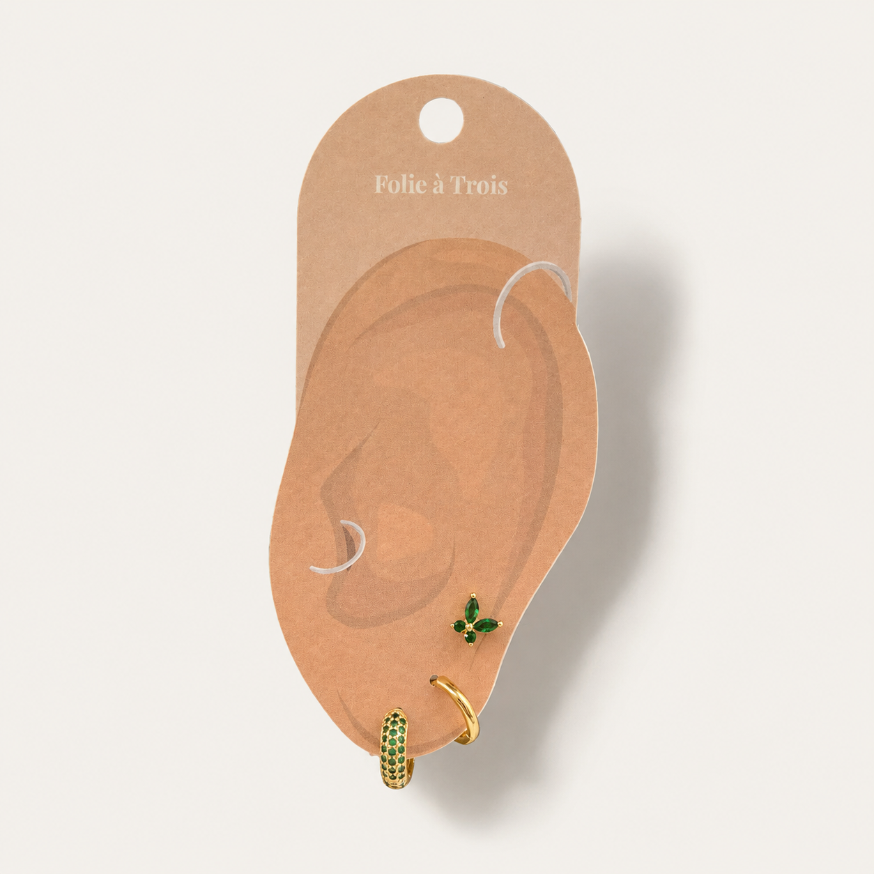 Three-piece Marigold SET gold earrings in green displayed on a Folie a Trois branded ear-shaped packaging card.