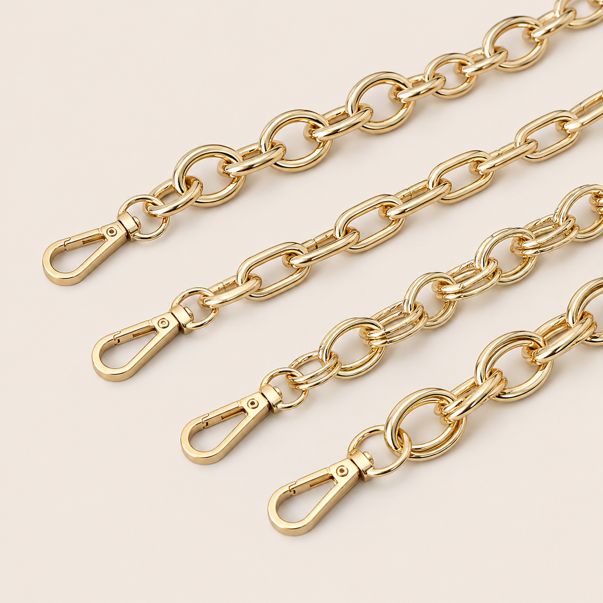 Four gold-toned metal link Marlow SHORT PHONE CHAIN straps with lobster clasp ends, fanned out diagonally on a light beige background.