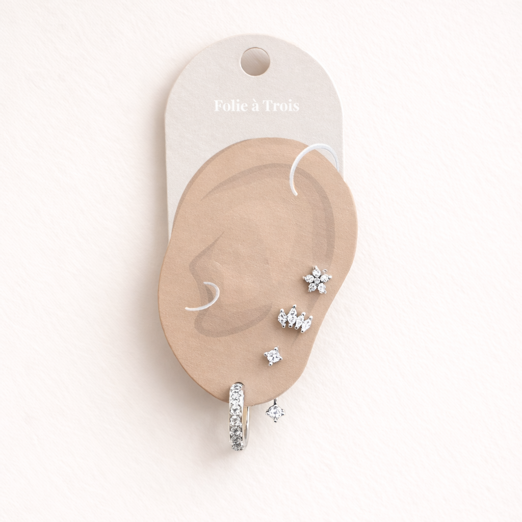 Melanie Set in silver tone, displayed on a Folie a Trois branded ear-shaped card with a pave hoop and three studs.