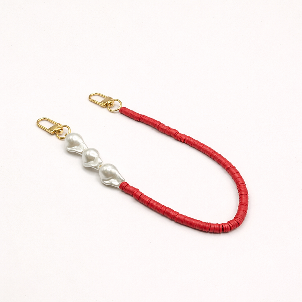 Red heishi bead Melody SHORT PHONE CORD with three baroque pearl accents, shown as a flat lay.