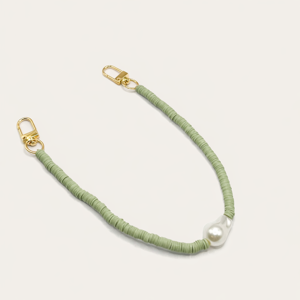 Green heishi bead Melody SHORT PHONE CORD with a baroque pearl accent, shown as a flat lay.