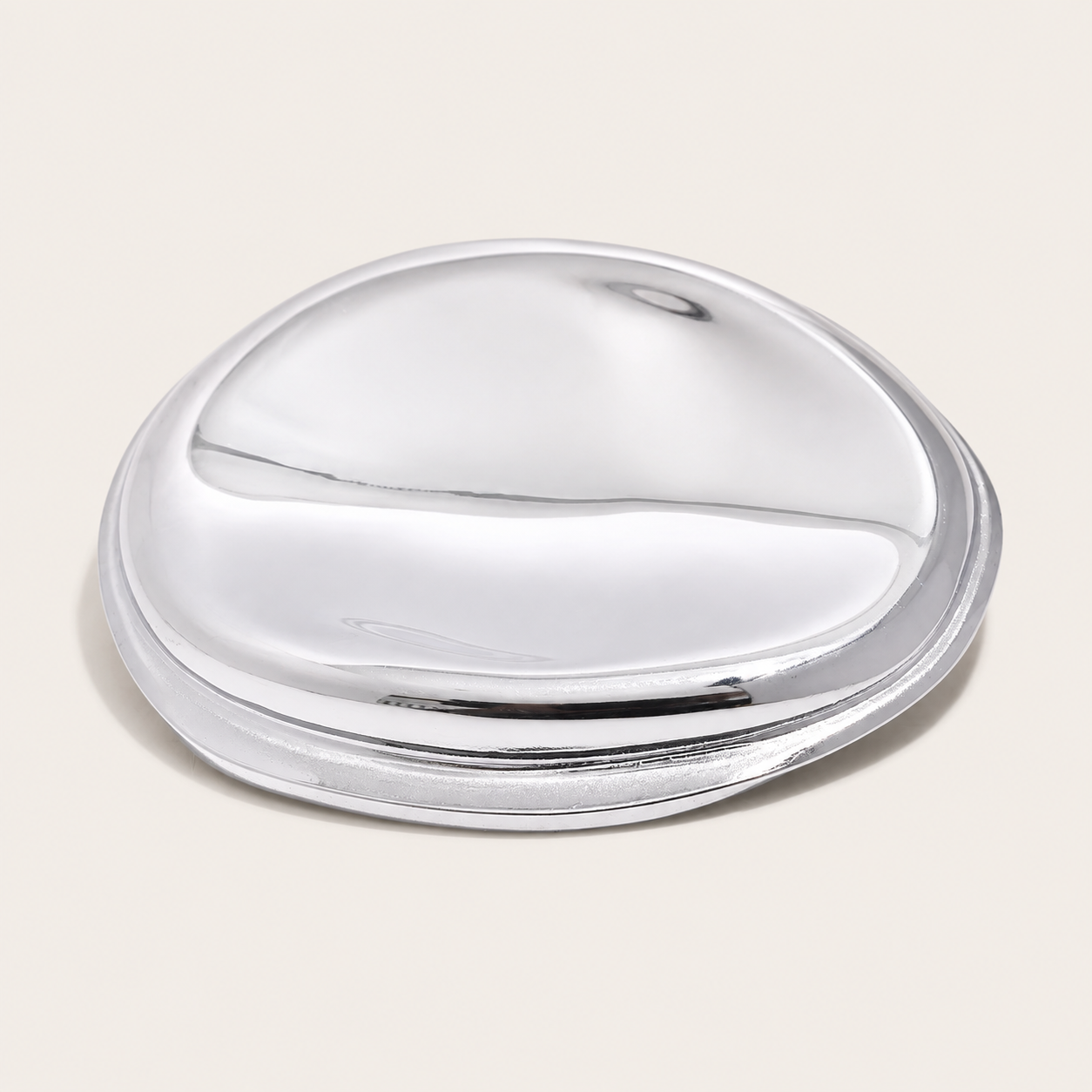 Silver molten pebble-shaped brooch with a glossy, sculptural finish on a cream backdrop — Folie à Trois Mina BROOCH.