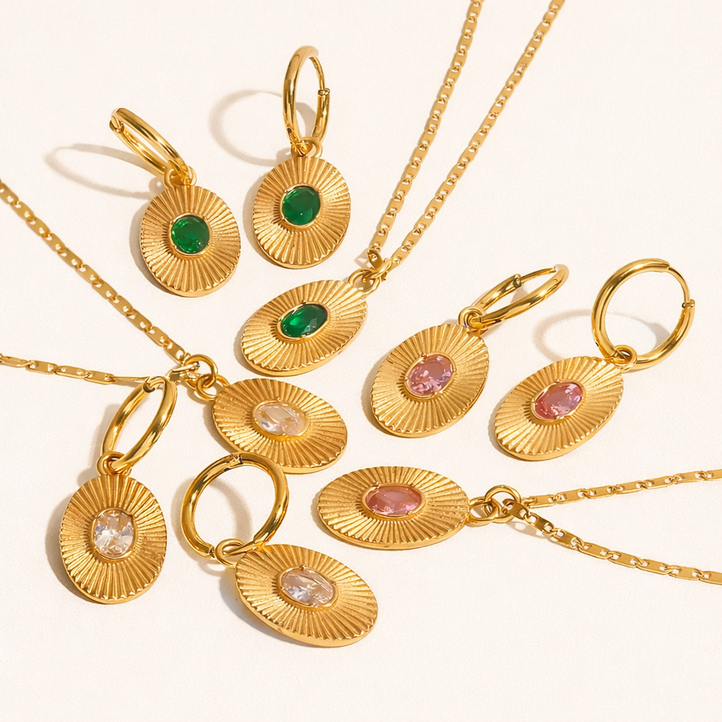 The More Than Friends NECKLACE collection, gold sunburst oval pendants and matching hoop earrings in green, pink, and clear stones.