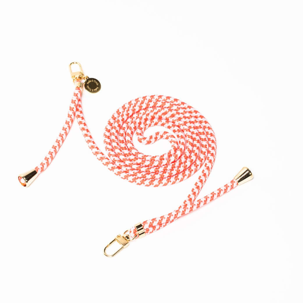 Coral and white patterned Multi Colorful PHONE CORD coiled with gold-tone hardware on a white background.