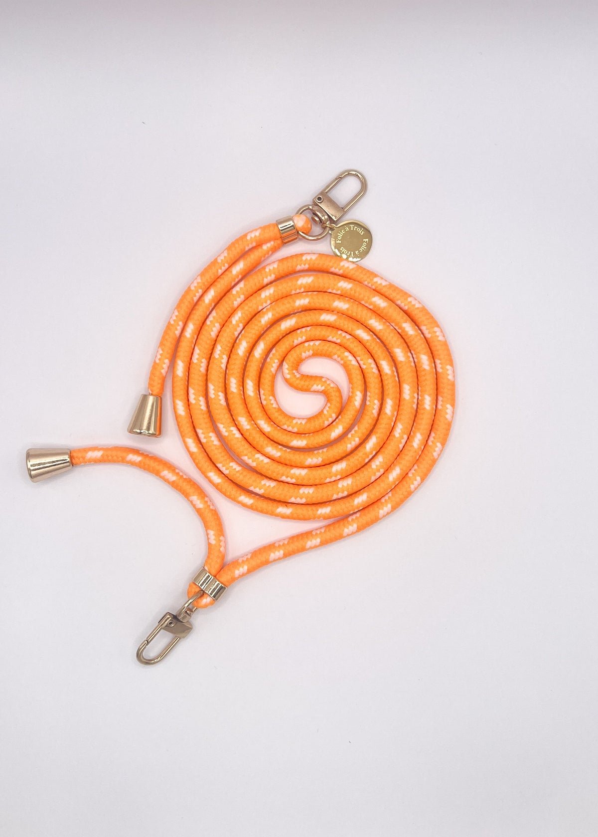 Orange and white patterned Multi Colorful PHONE CORD coiled with silver-tone hardware on a white background.