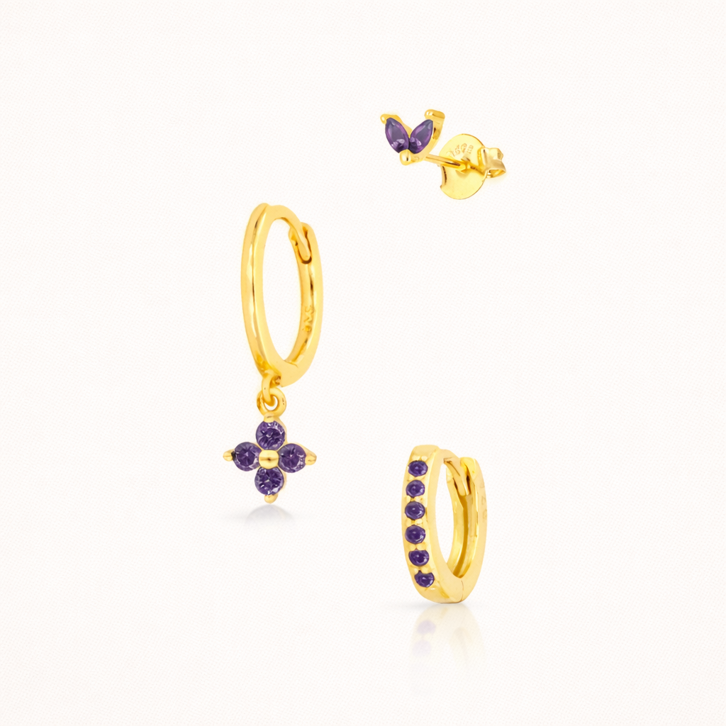 The New Perspective SET in gold with amethyst purple stones, showing the marquise stud, flower dangle hoop, and pavé hoop in studio.
