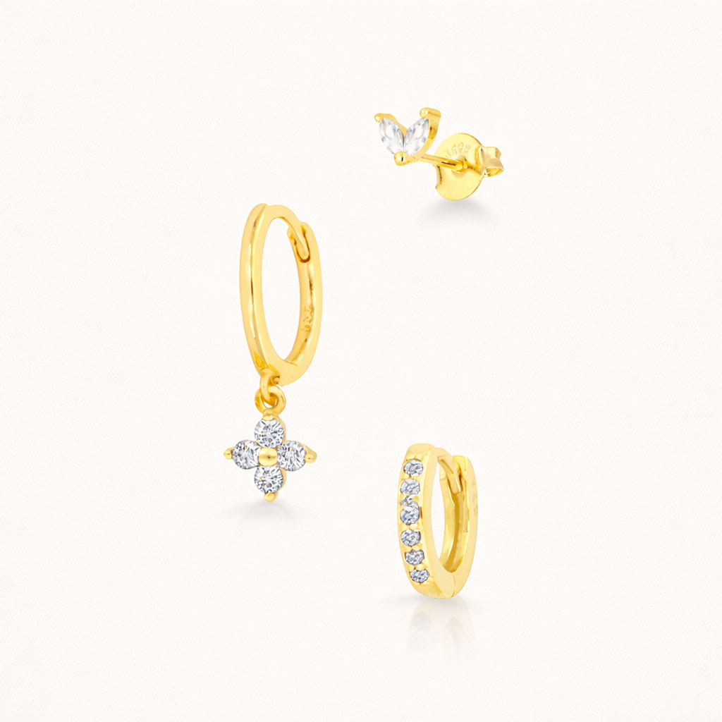 The New Perspective SET in gold with clear crystal stones, featuring the marquise stud, flower dangle hoop, and pavé hoop in studio.