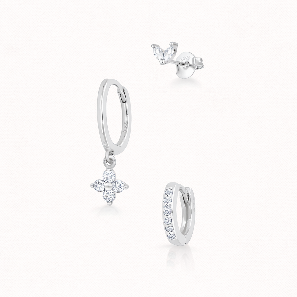 The New Perspective SET in silver with clear crystal stones, showing the marquise stud, flower dangle hoop, and pavé hoop in studio.
