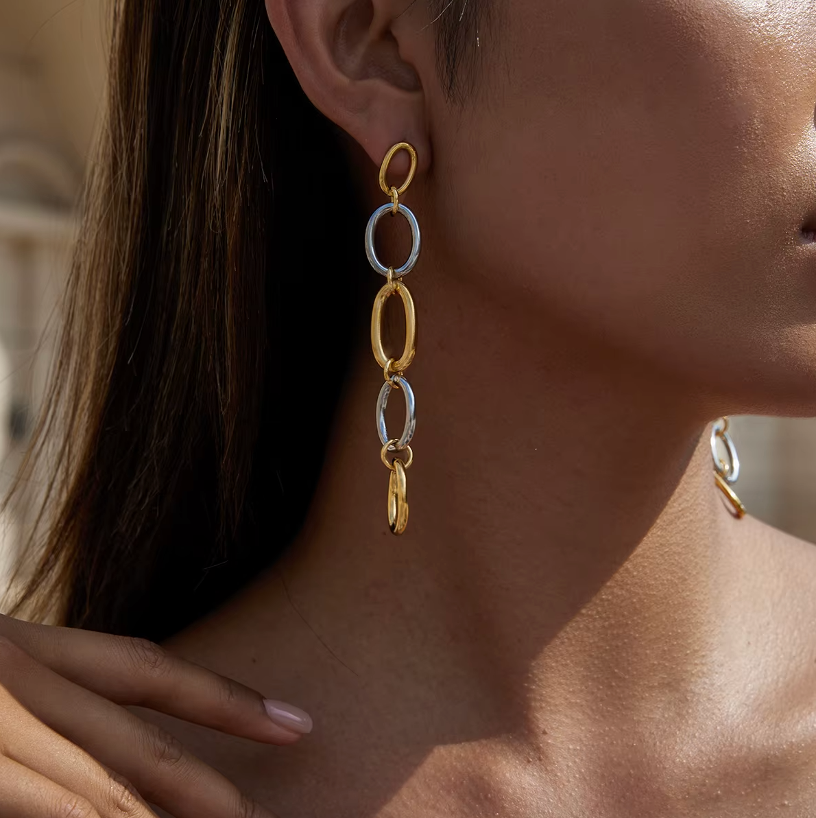 Worn along the ear, the No Apologies EARRINGS cascade in soft light with their alternating oval links.