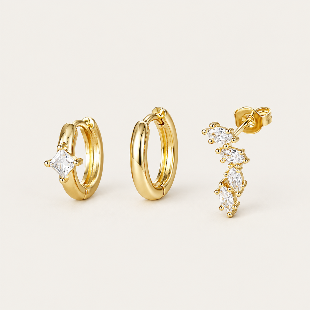 Three gold Folie à Trois Odile SET pieces: a plain hoop, a hoop set with a square crystal, and a marquise climber stud.