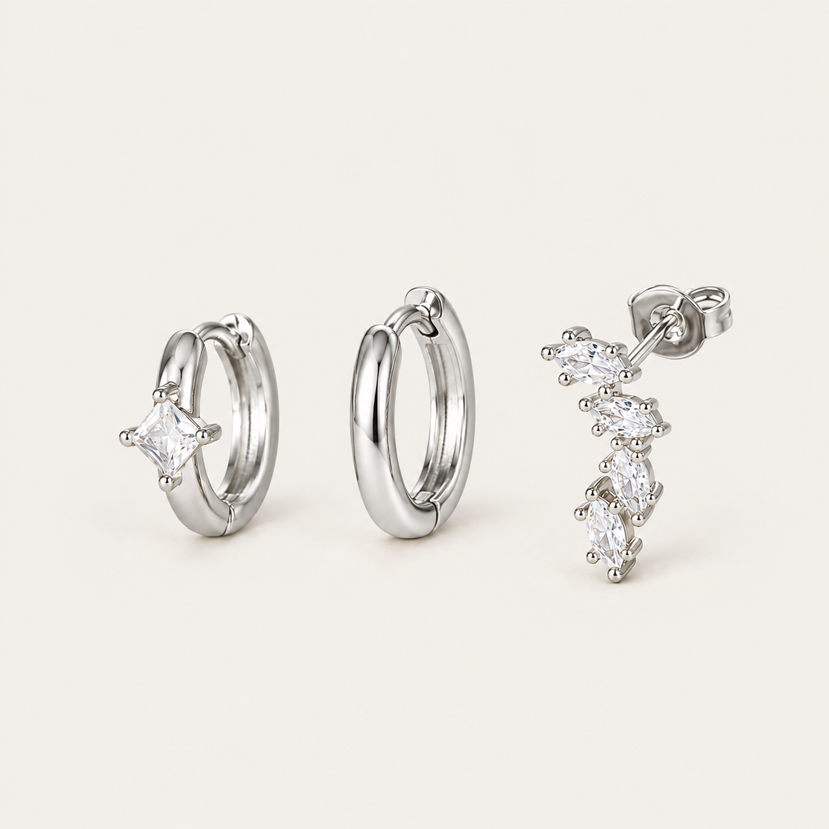 The Folie à Trois Odile SET in silver: a plain hoop, a hoop set with a square crystal, and a marquise climber stud.