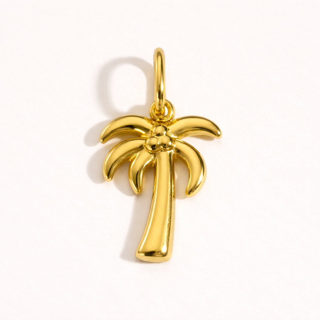 The Palm Tree CHARM in polished gold, its curved fronds and beaded coconuts shown alone on a plain white studio background.