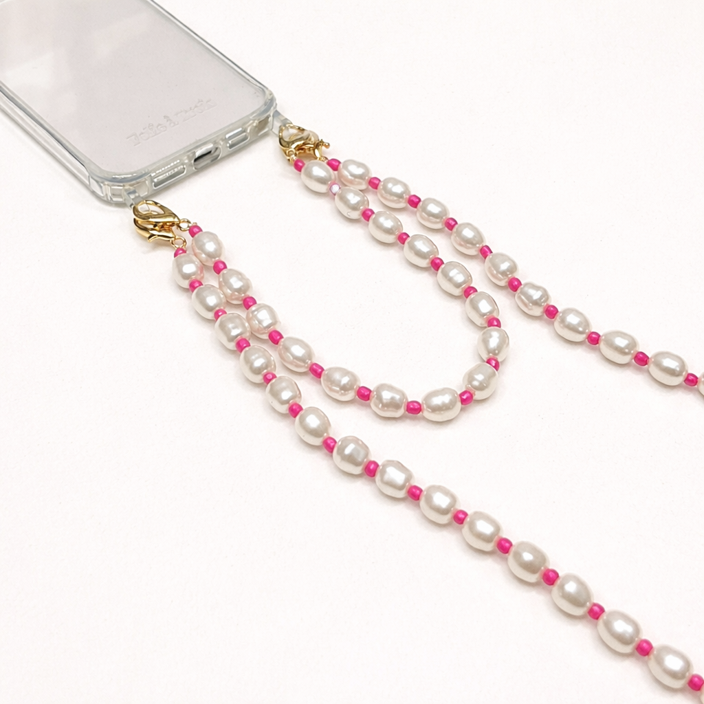 Close-up of the white pearl and pink bead Posy Pearl LONG PHONE STRAP clasps attached to a clear phone case.